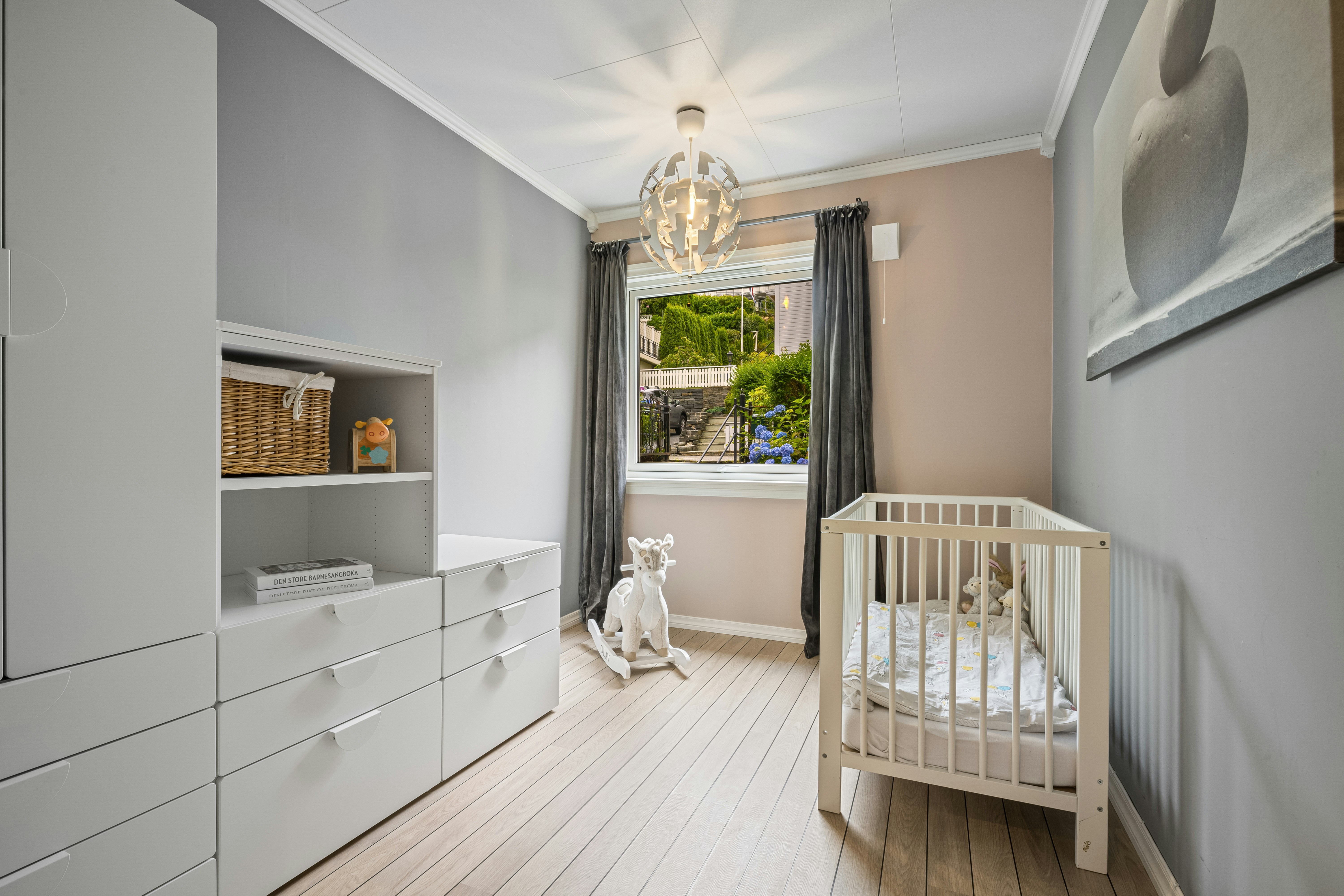 A baby's room with a crib and dresser